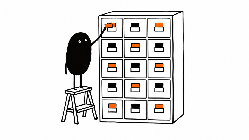 Lev sticks a coloured tab onto a drawer of a tall filing cabinet where every drawer is tabbed.